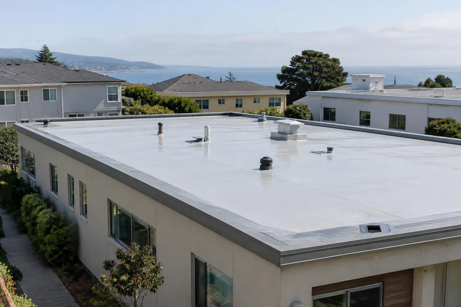 Low-slope roof with visible drainage features on a Northern California building
